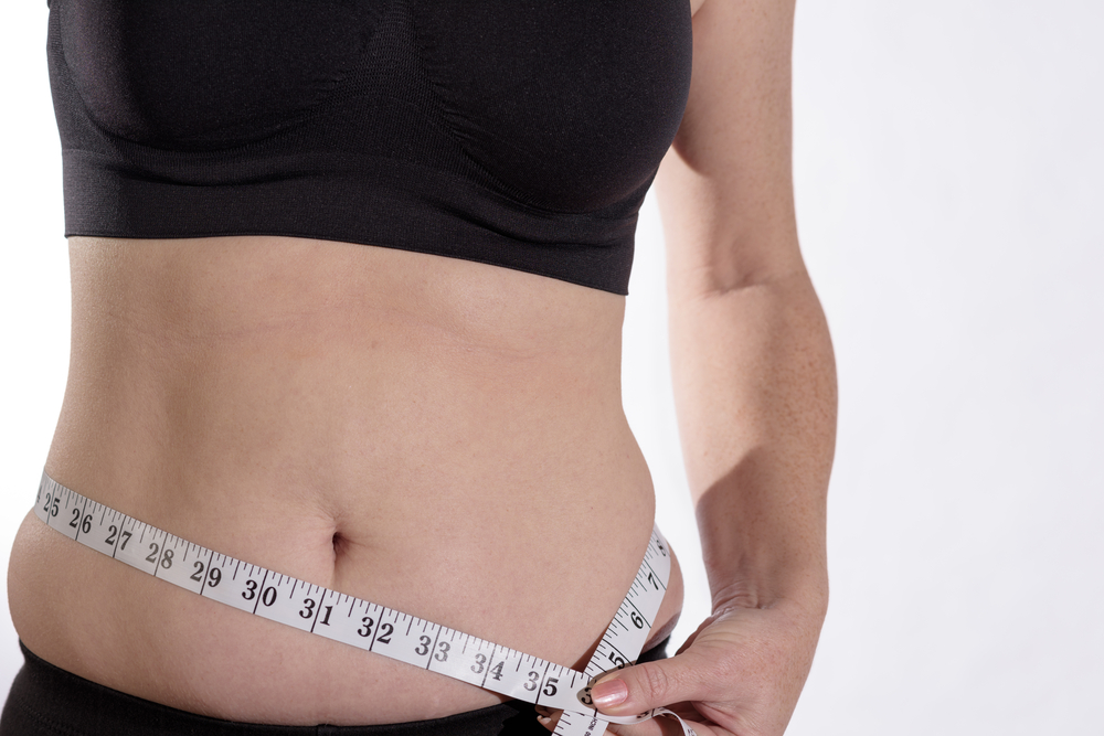 Women measuring her waist 